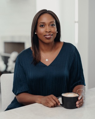 Faith, seated at a counter with a coffee